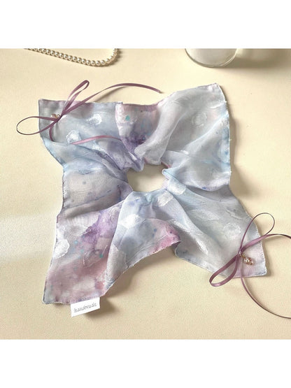 Flat lay of multiple Gifty ombre scrunchies in different pastel shades