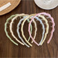 Side view of Gifty solid color wavy headband highlighting wave design