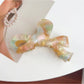 Beau delicate bow hair claw clip displayed with natural lighting