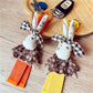 Fabric rabbit shaped keychain in beige with stitched details and a metal keyring