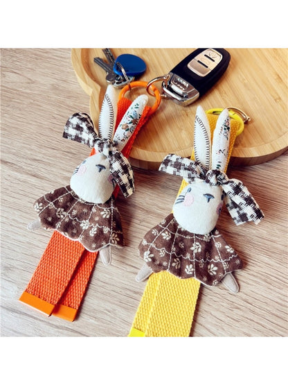 Fabric rabbit shaped keychain in beige with stitched details and a metal keyring