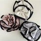 Gifty Neat Silky Zesty Scrunchie wrapped around a ponytail on model with dark hair