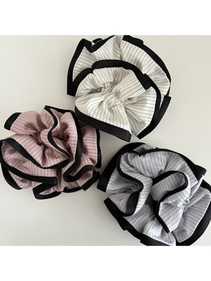 Gifty Neat Silky Zesty Scrunchie wrapped around a ponytail on model with dark hair
