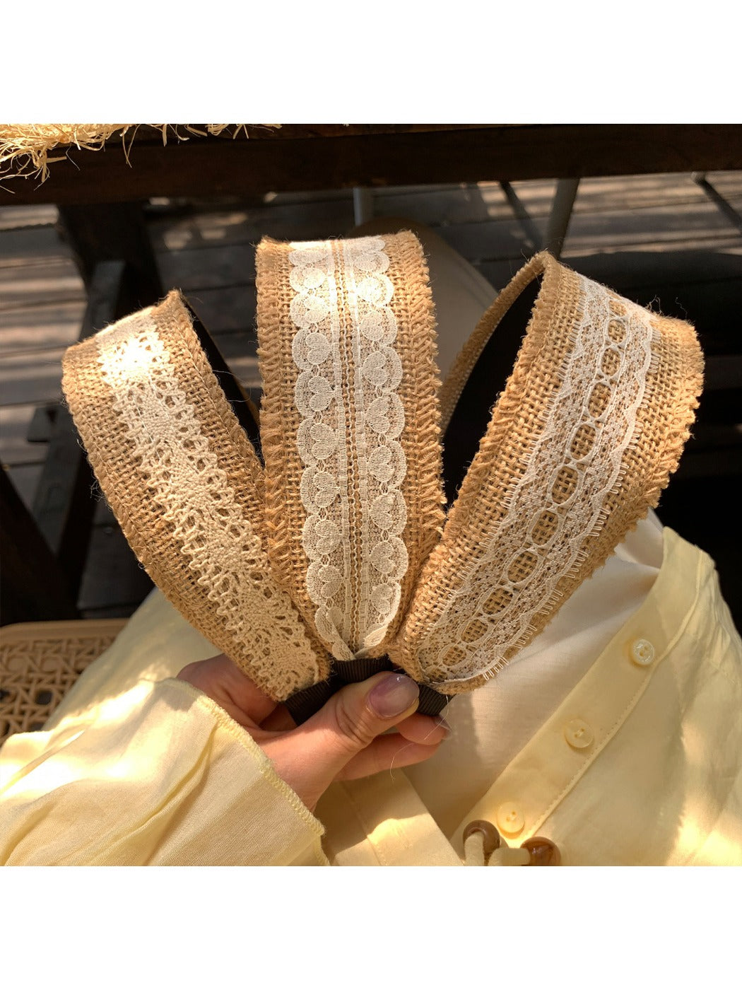 Side view of Gifty soft straw lace headband highlighting its flexible band
