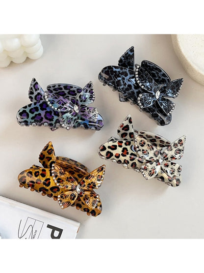 Beau claw clip showing leopard print pattern and butterfly detail from side angle