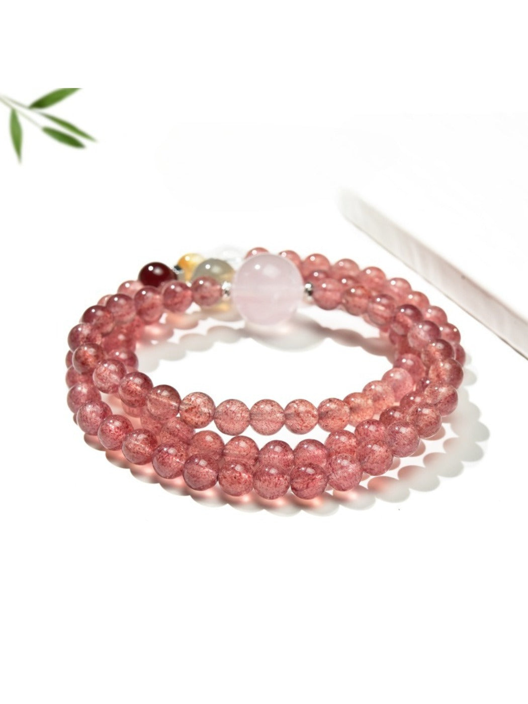 Lovra triple wrap bracelet styled with a casual outfit, emphasizing the pink crystal beads