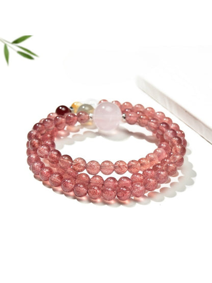 Lovra triple wrap bracelet styled with a casual outfit, emphasizing the pink crystal beads