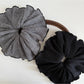 Side view of Gifty vintage plaid fabric scrunchie showing gathered fabric texture