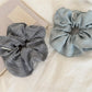 Close-up of vintage minimalist stripe scrunchie in neutral tones on white background