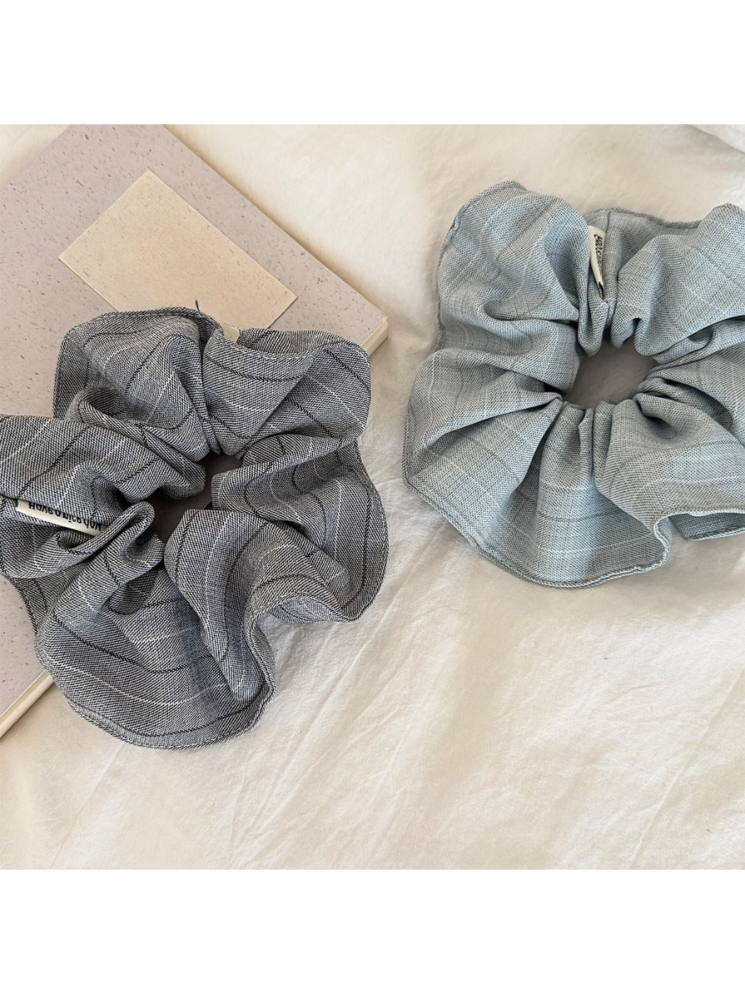 Close-up of vintage minimalist stripe scrunchie in neutral tones on white background