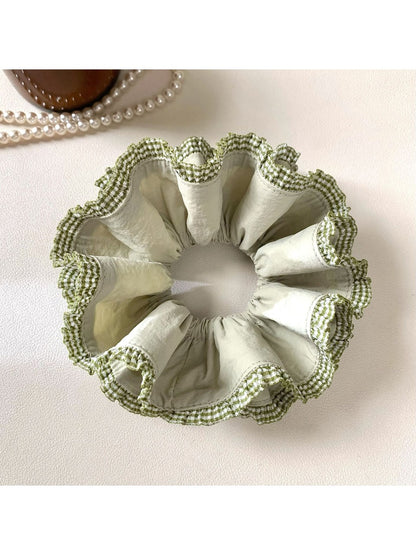 Green double layer scrunchie displayed on a white background showing its full shape