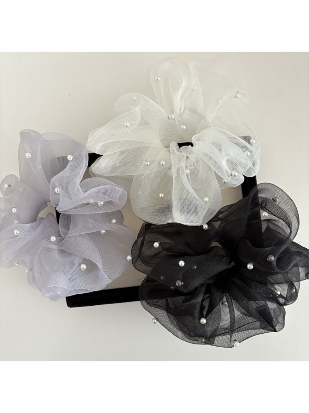 Close-up of Gifty elegant chic tulle scrunchie in soft beige color