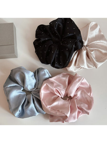 Close-up of Gifty rhinestone decor satin scrunchie in soft pink with sparkling rhinestones