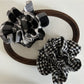 Black and white checkered vintage scrunchie on a white background
