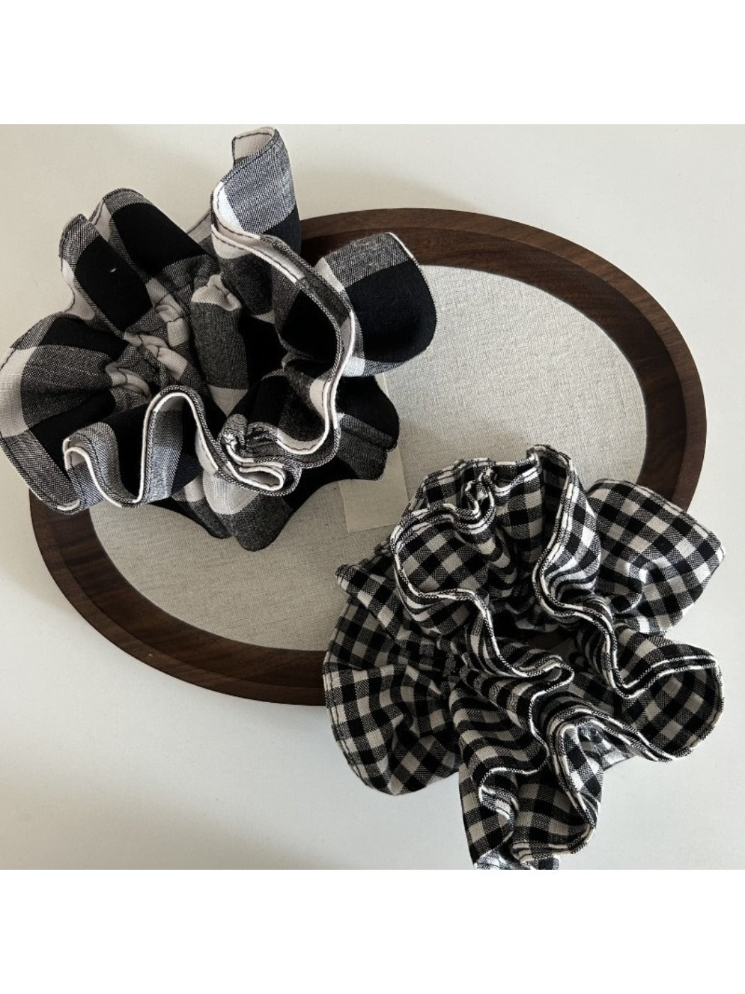 Black and white checkered vintage scrunchie on a white background