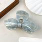 Beau iridescent bow hair claw clip reflecting pastel colors
