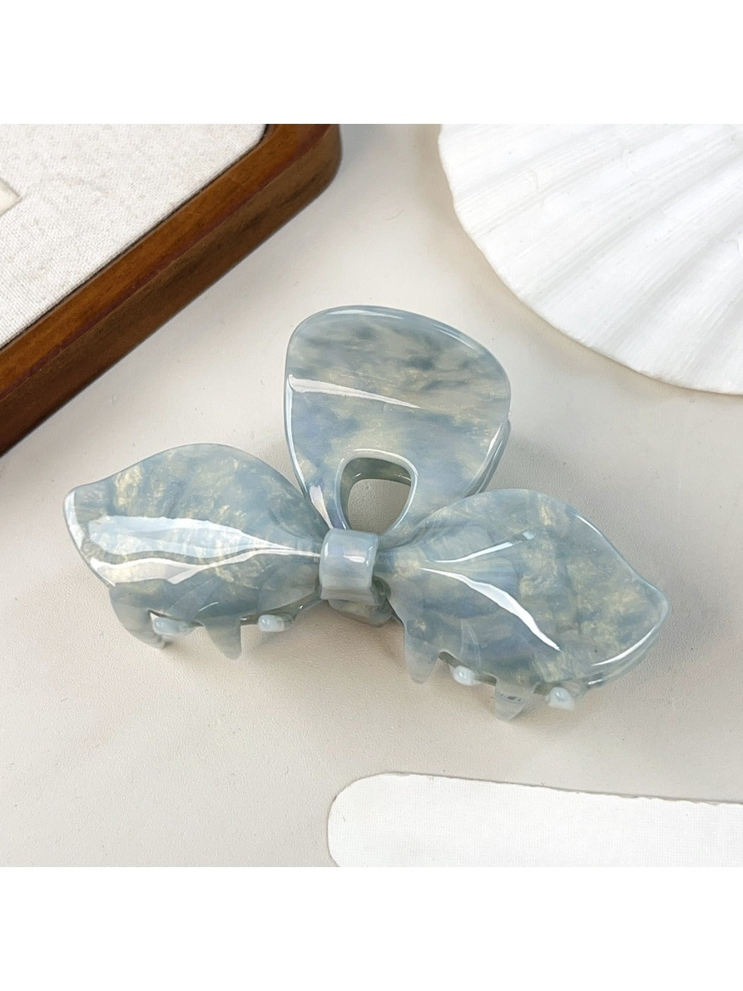 Beau iridescent bow hair claw clip reflecting pastel colors