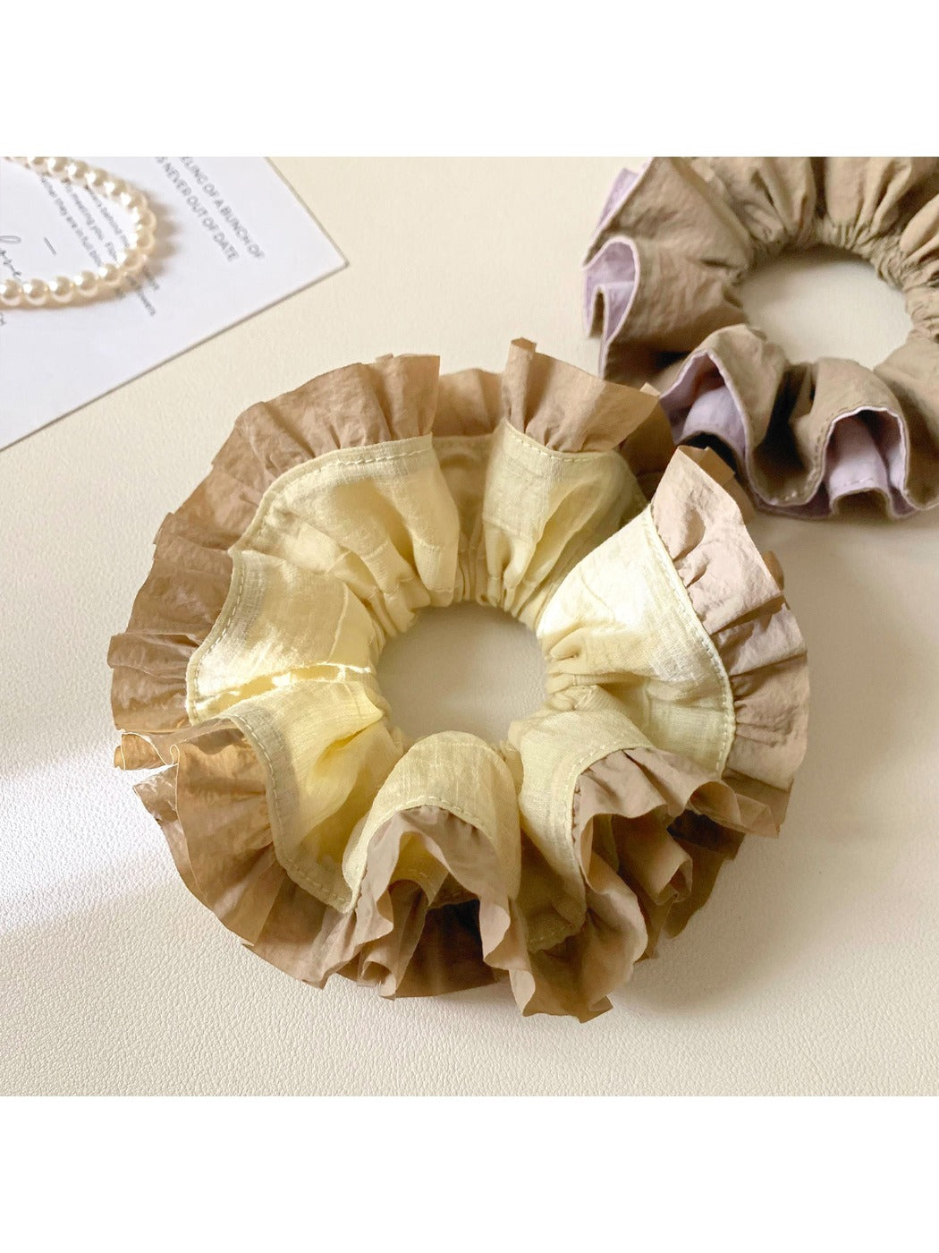Vintage yellow ruffle scrunchie displayed on a white background