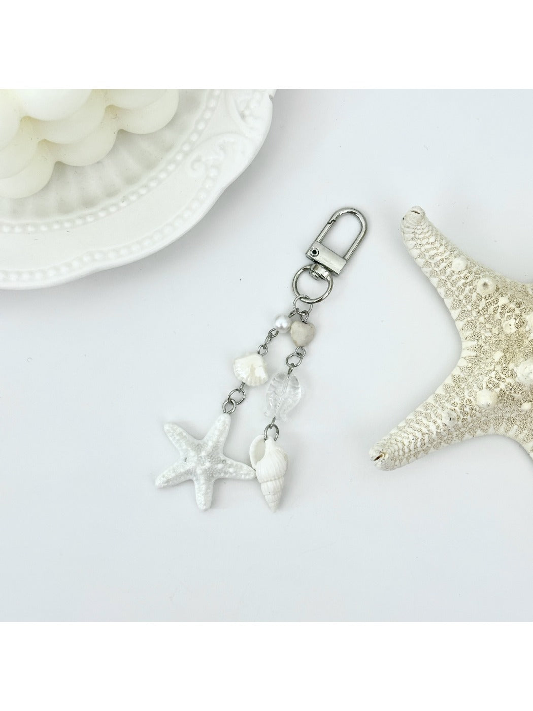 Starfish shaped pendant keychain with a metallic finish