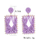 Side view of raffia wrapped square earrings showing texture and detail