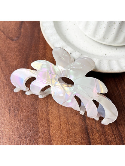 Beau sweet chic flower claw clip styled in hair from back view