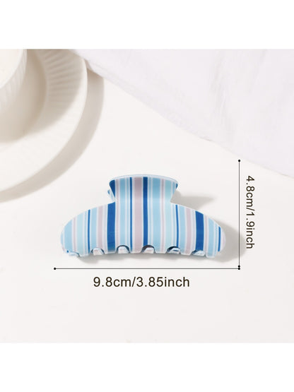 Beau half moon claw clip placed on wooden surface with natural light