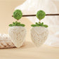 Top view of strawberry earrings showing woven raffia pattern
