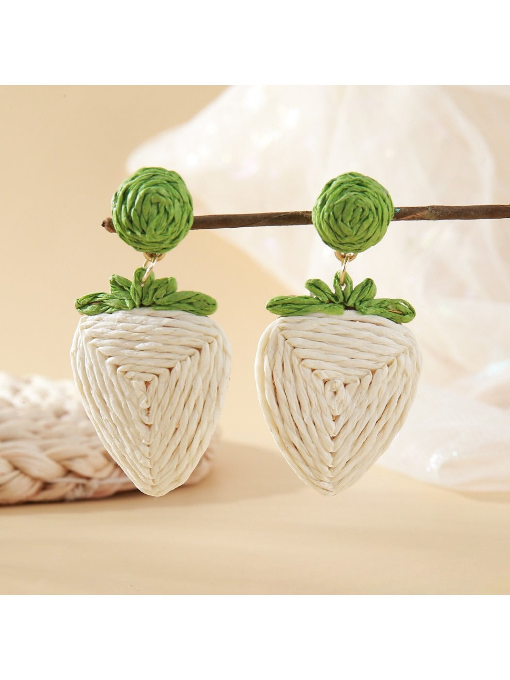 Top view of strawberry earrings showing woven raffia pattern