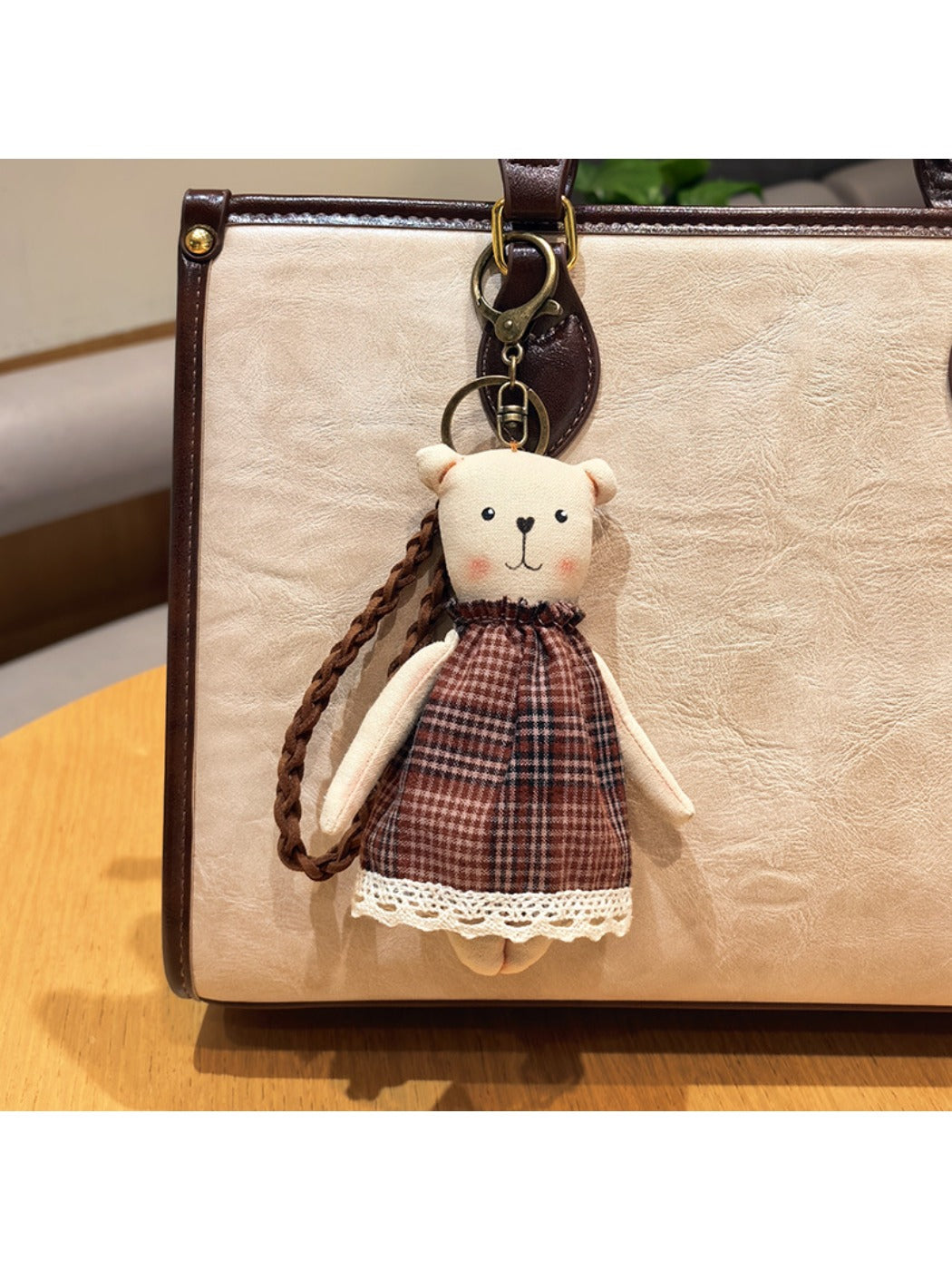 Back view of cartoon bear charm keychain showing plain brown surface