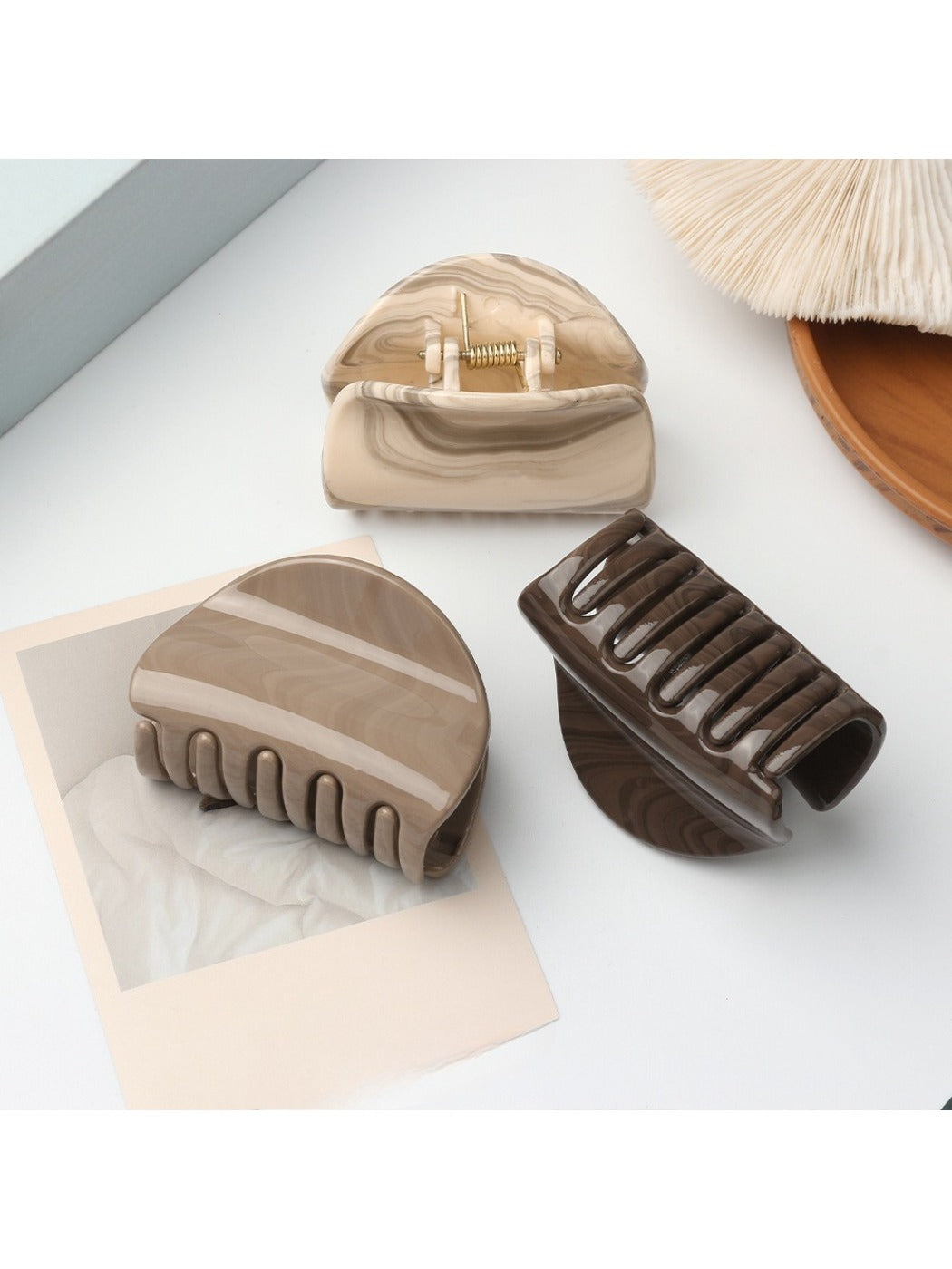 Close-up of Beau half circle hair clip showing smooth matte gold finish
