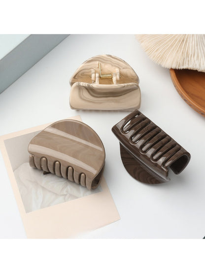 Close-up of Beau half circle hair clip showing smooth matte gold finish