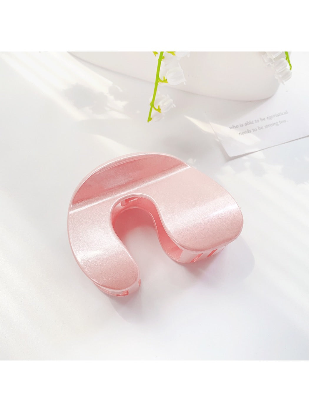 Beau arched hair claw clip open showing inner teeth and spring detail