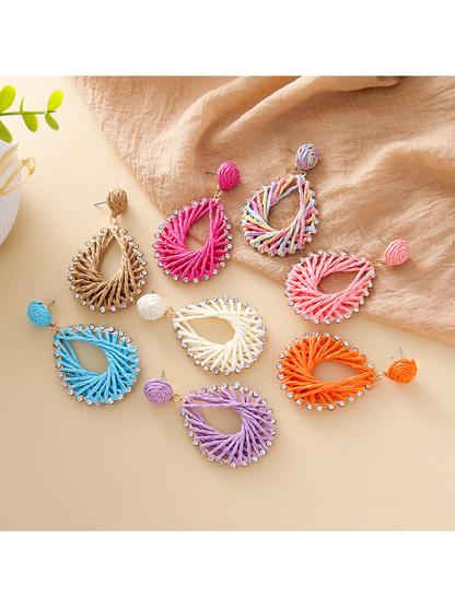 Close-up of Earedge Bohemian geometric raffia drop earrings on white background