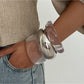 Close-up of Lovra wide band bangle bracelet showing smooth finish