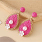 Earedge earrings in teardrop shape with polished metal finish close-up