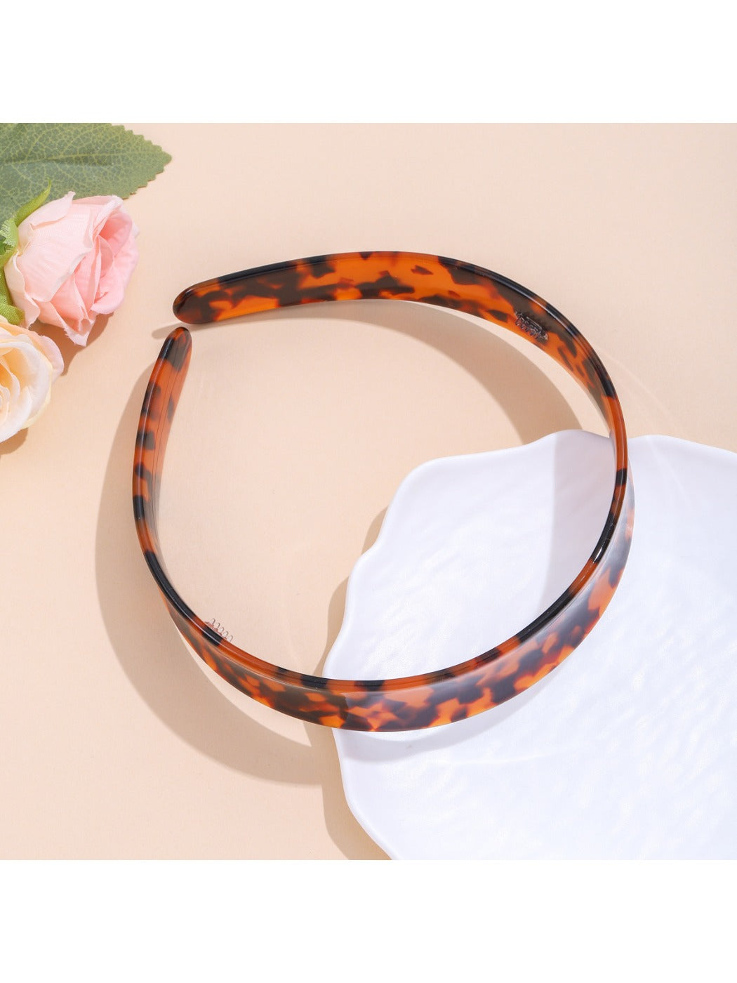 Leopard print headband displayed flat to show full pattern and colors