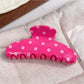 Beau polka dot half circle claw clip with metal spring mechanism visible