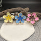 Beau lively sunny flower hair clip attached to blonde hair, showing side view