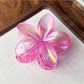 Beau flower shaped claw clip shown from bottom angle revealing clip teeth