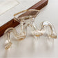 Model styling hair with Beau wave-shaped hair claw clip in natural light
