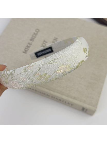 Gifty flower headband with pink, white, and green embroidered floral design