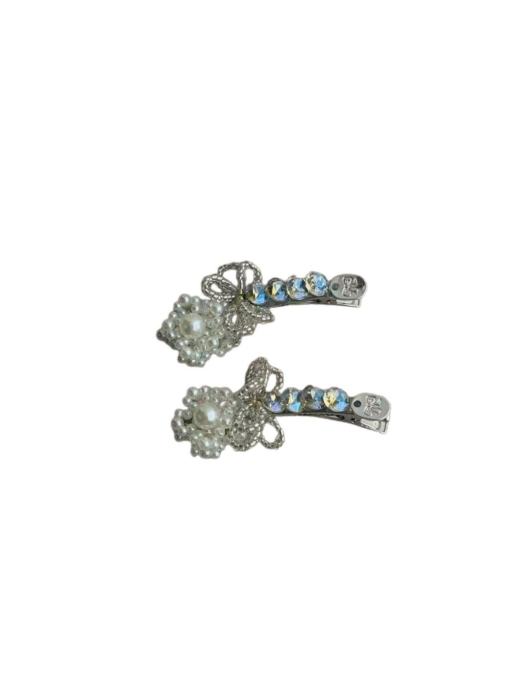 Beau rhinestone bow hair clip displayed on a wooden surface