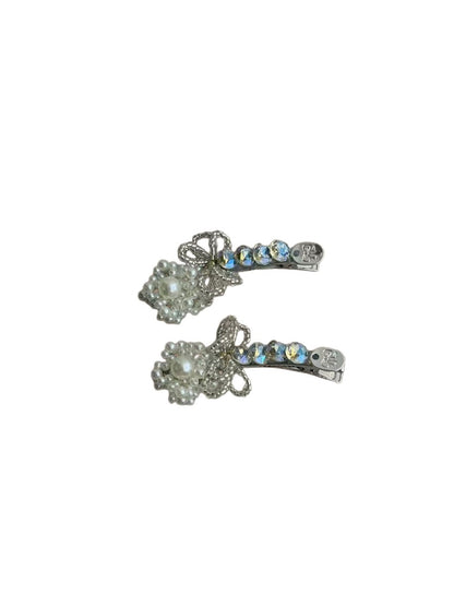 Beau rhinestone bow hair clip displayed on a wooden surface