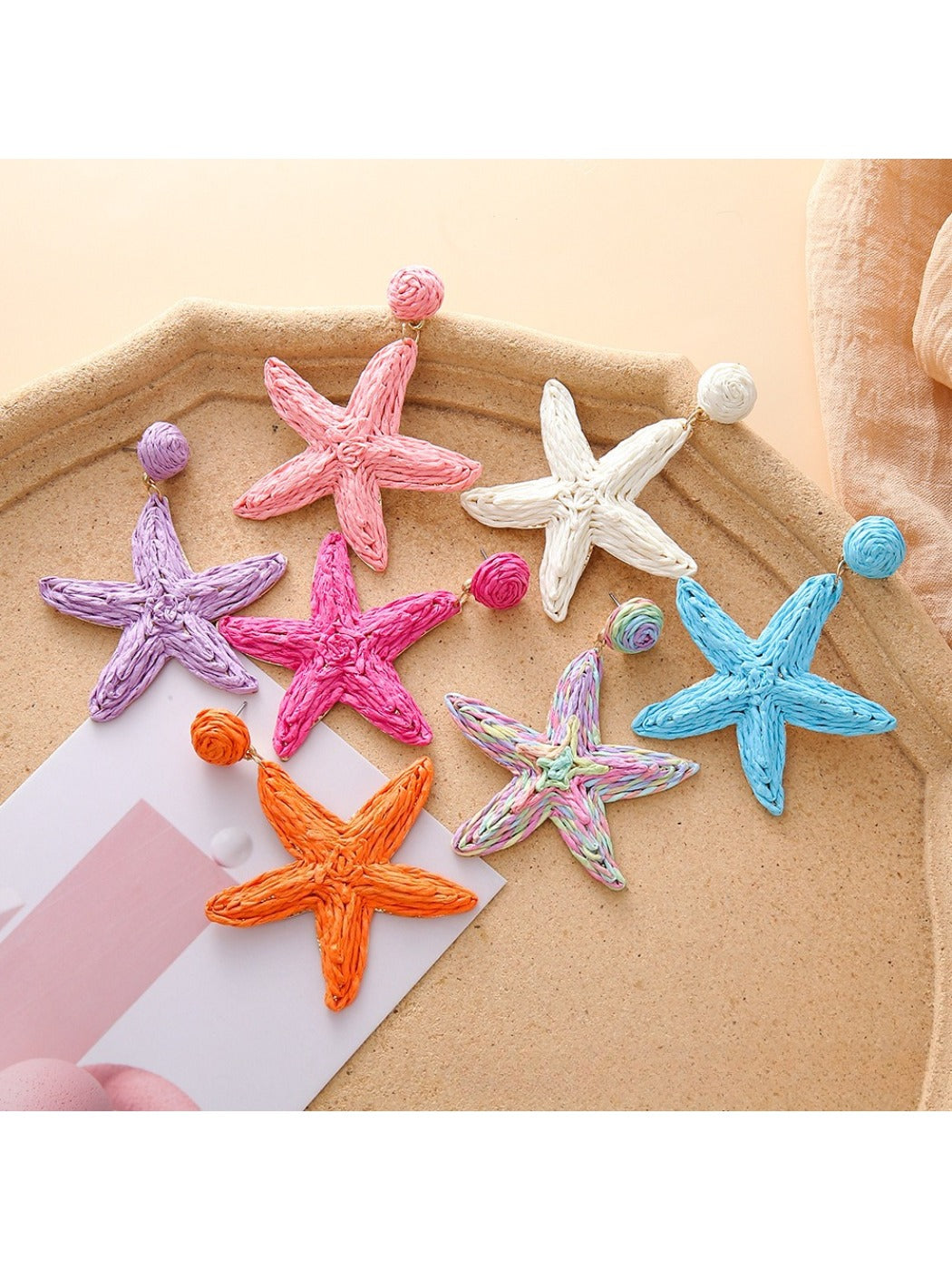Close-up of Earedge starfish shaped drop earrings in silver finish