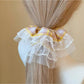 Side view of yellow plaid scrunchie showing gathered fabric
