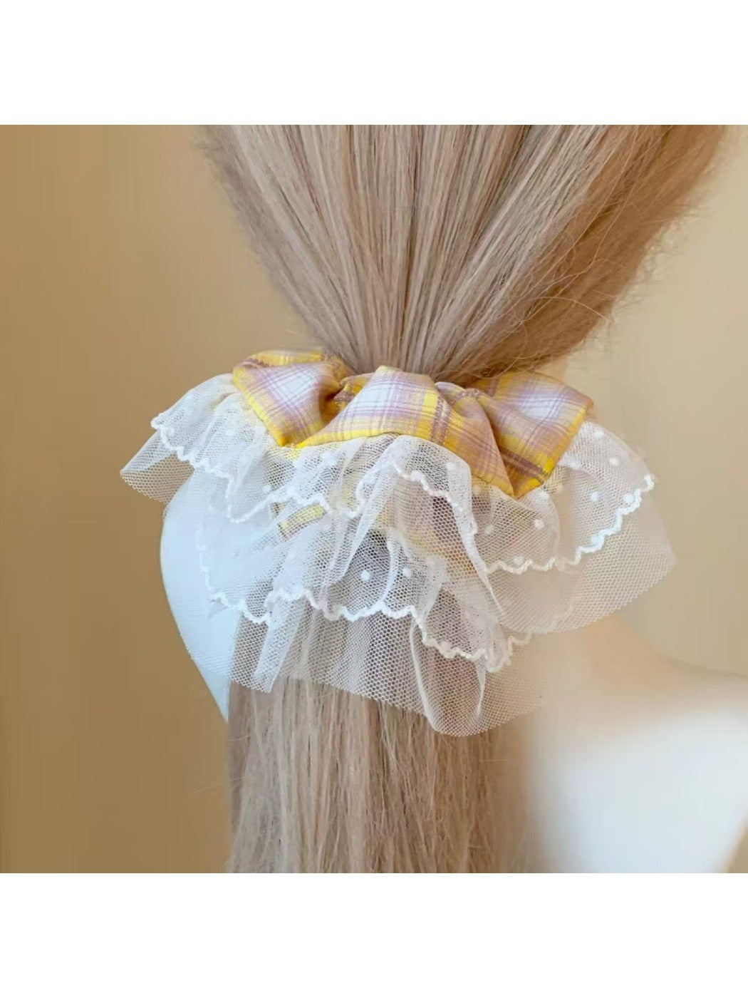 Side view of yellow plaid scrunchie showing gathered fabric