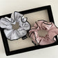 Top view of Gifty scrunchie showing soft fabric and colorful stripes