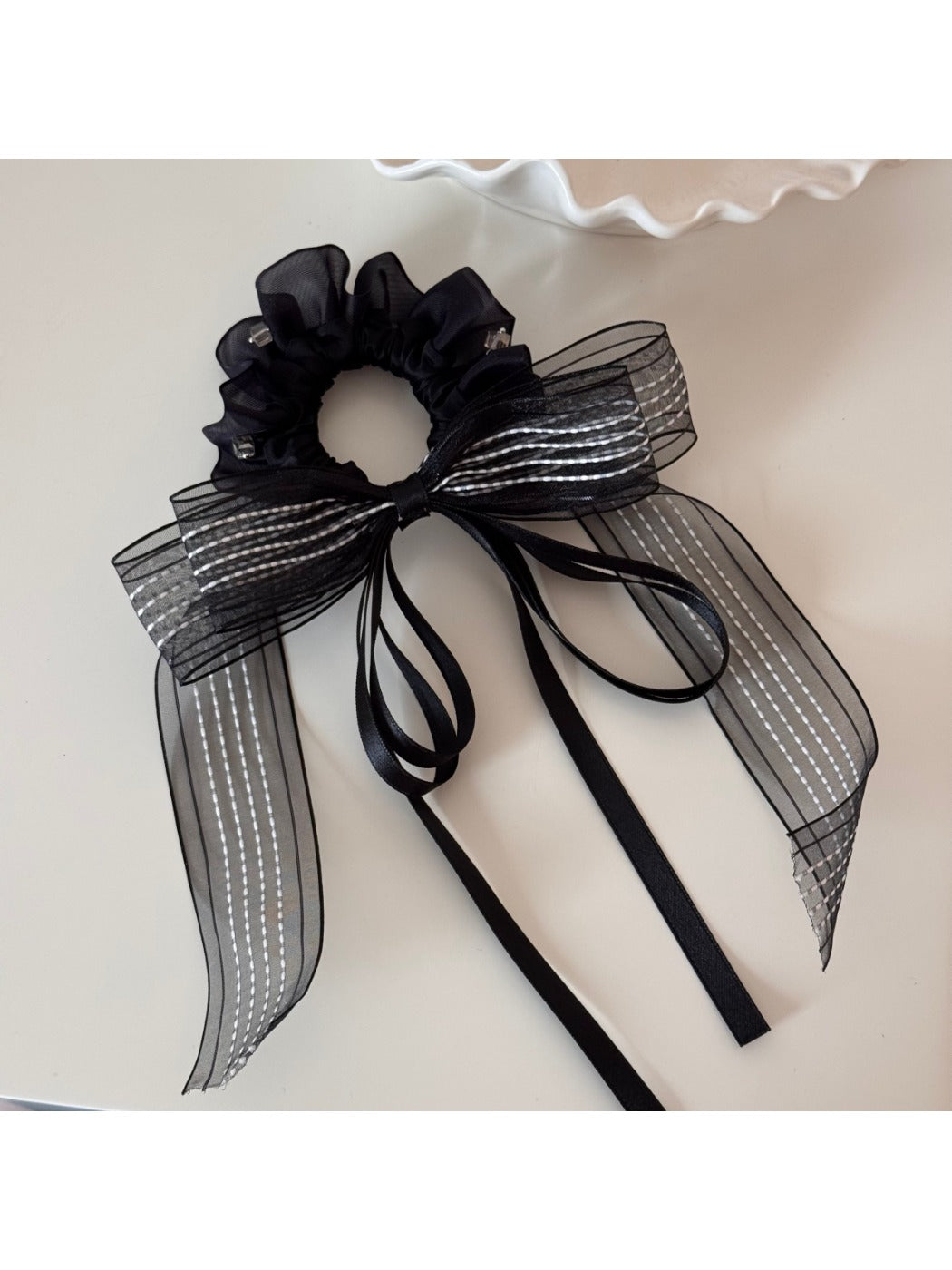Gifty scrunchie worn in hair, showcasing its volume and layered ribbons
