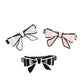 Side view of Beau bow hair clip highlighting its curved shape and clasp