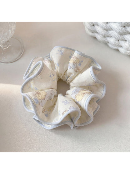 Gifty scrunchie styled in hair, highlighting its vibrant cartoon pattern and texture